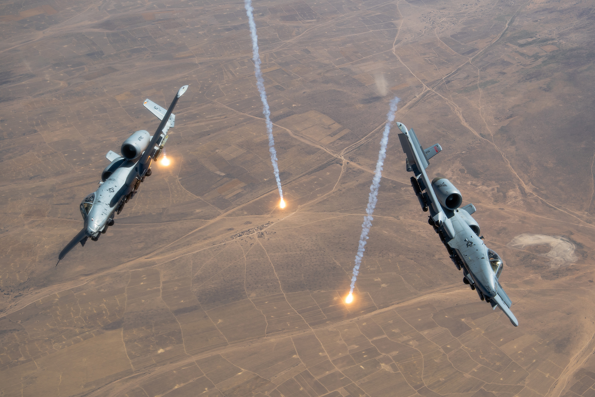 Two U.S. Air Force A-10 Thunderbolt IIs release countermeasure flares over the U.S. Central Command area of responsibility, July 23, 2020.