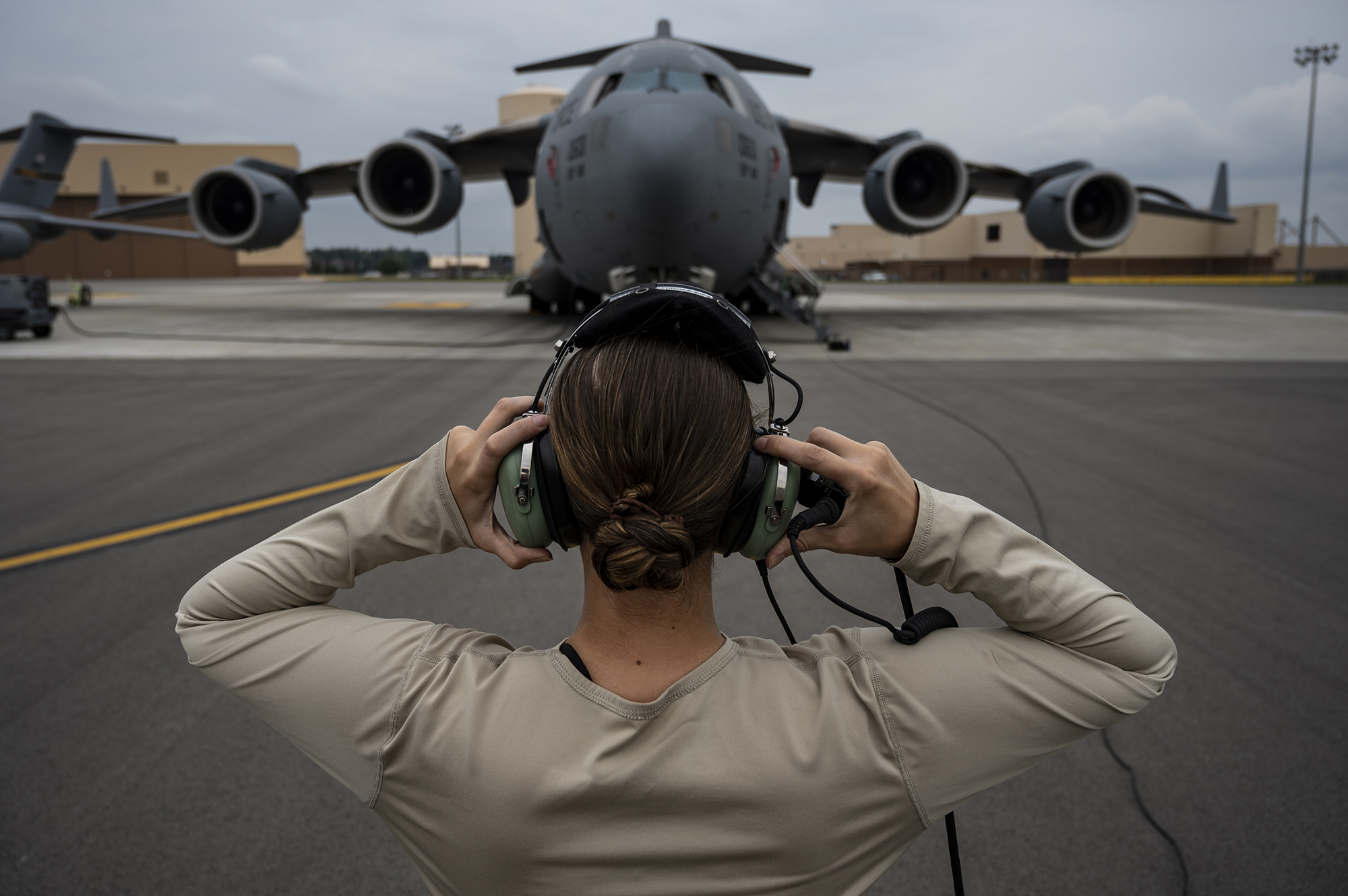 Senior Airman Sara Gutherie, 911th Aircraft Maintenance Squadron instruments and controls technician, adjusts her headset to communicate with maintainers inside the C-17 Globemaster III during an inspection at the Pittsburgh International Airport Air Reserve Station, Pa., Sept. 17, 2020.